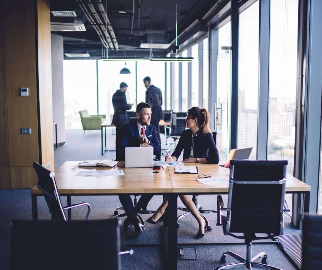 Two accountants consolidating their financial statements