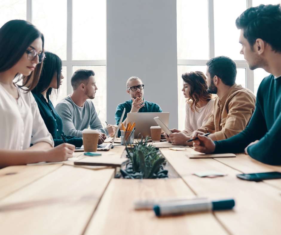 People in conference room discussing enterprise accounting software.