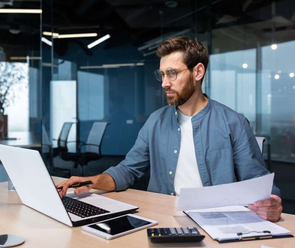 Man on computer using bookkeeping software